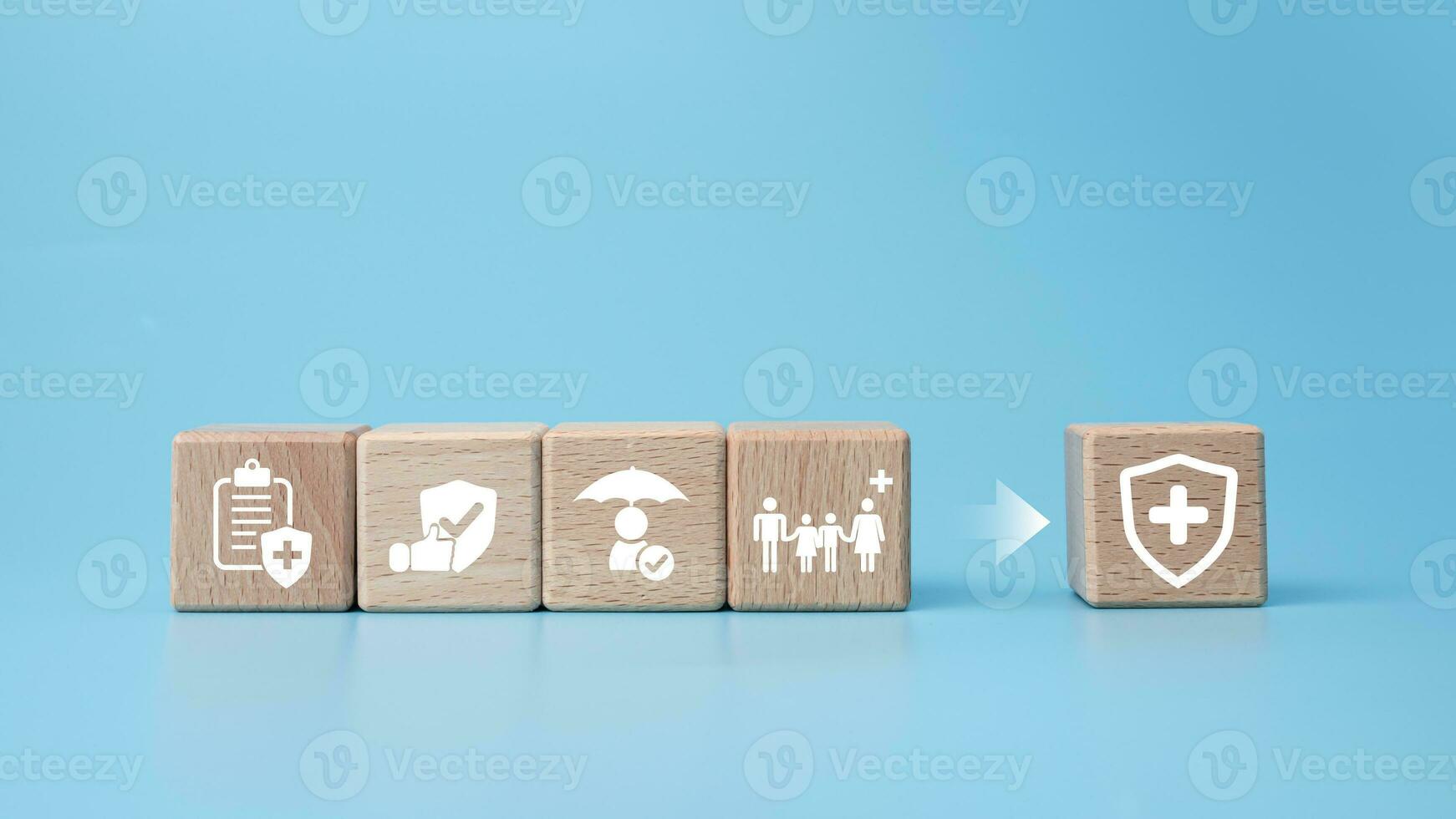 Concept of health insurance and medical. Wooden block with icons about health insurance and access to health care, health care planning on a blue background. photo