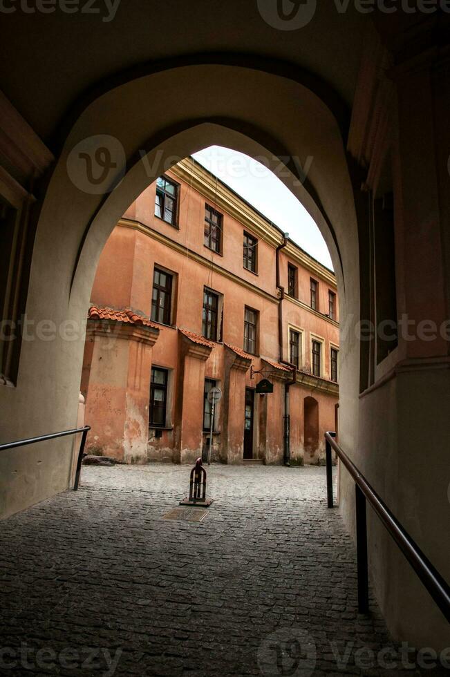 View from the arch on the narrow street in the city photo