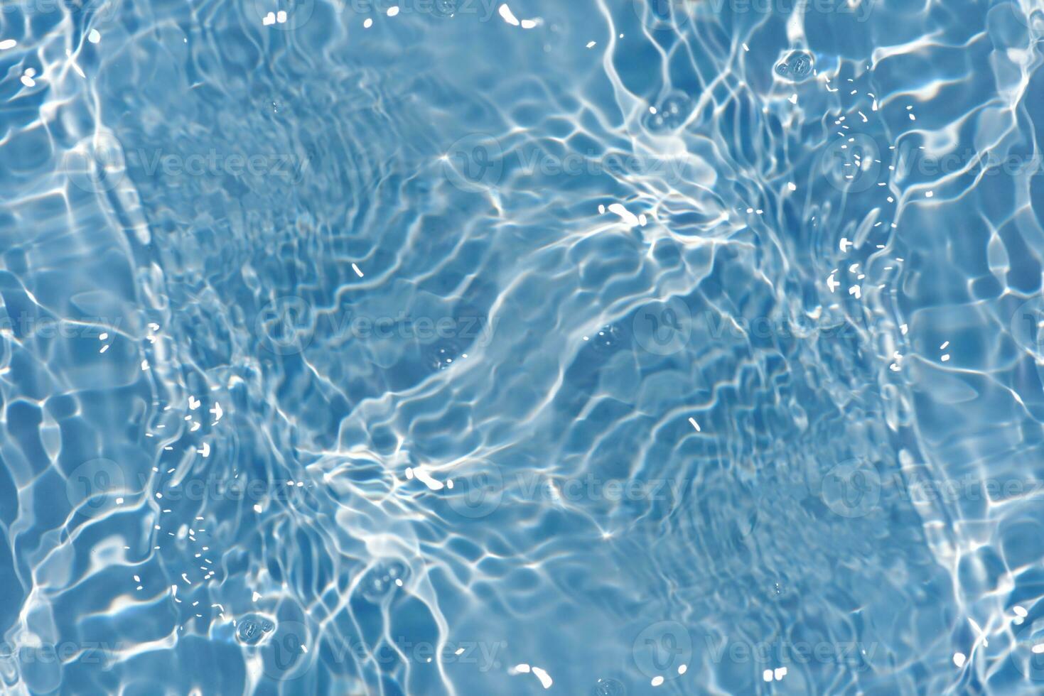 Defocus blurred transparent blue colored clear calm water surface texture with splashes reflection. Trendy abstract nature background. Water waves in sunlight with copy space. Blue watercolor shine. photo