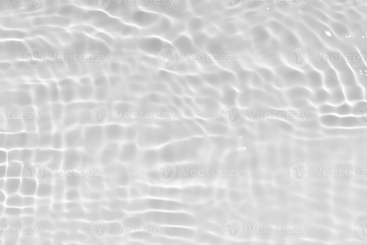 White water with ripples on the surface. Defocus blurred transparent white colored clear calm water surface texture with splashes and bubbles. Water waves with shining pattern texture background. photo