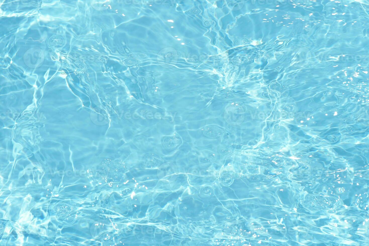 Blue water with ripples on the surface. Defocus blurred transparent white-black colored clear calm water surface texture with splash and bubbles. Water waves with shining pattern texture background. photo