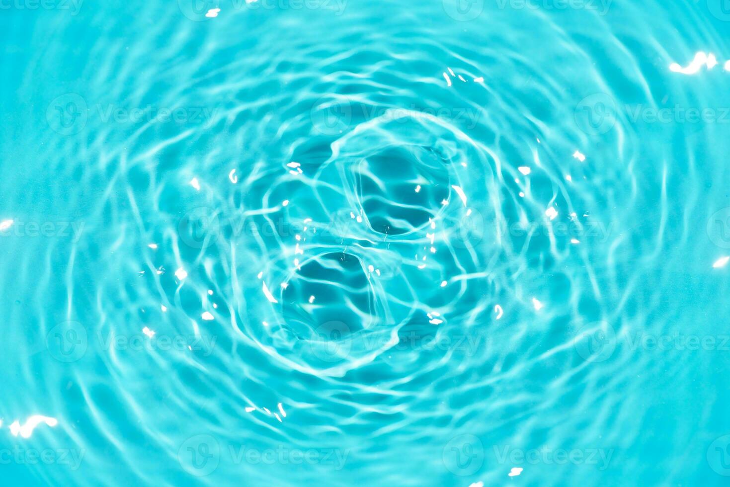 Defocus blurred transparent blue colored clear calm water surface texture with splashes reflection. Trendy abstract nature background. Water waves in sunlight with copy space. Blue watercolor shine. photo