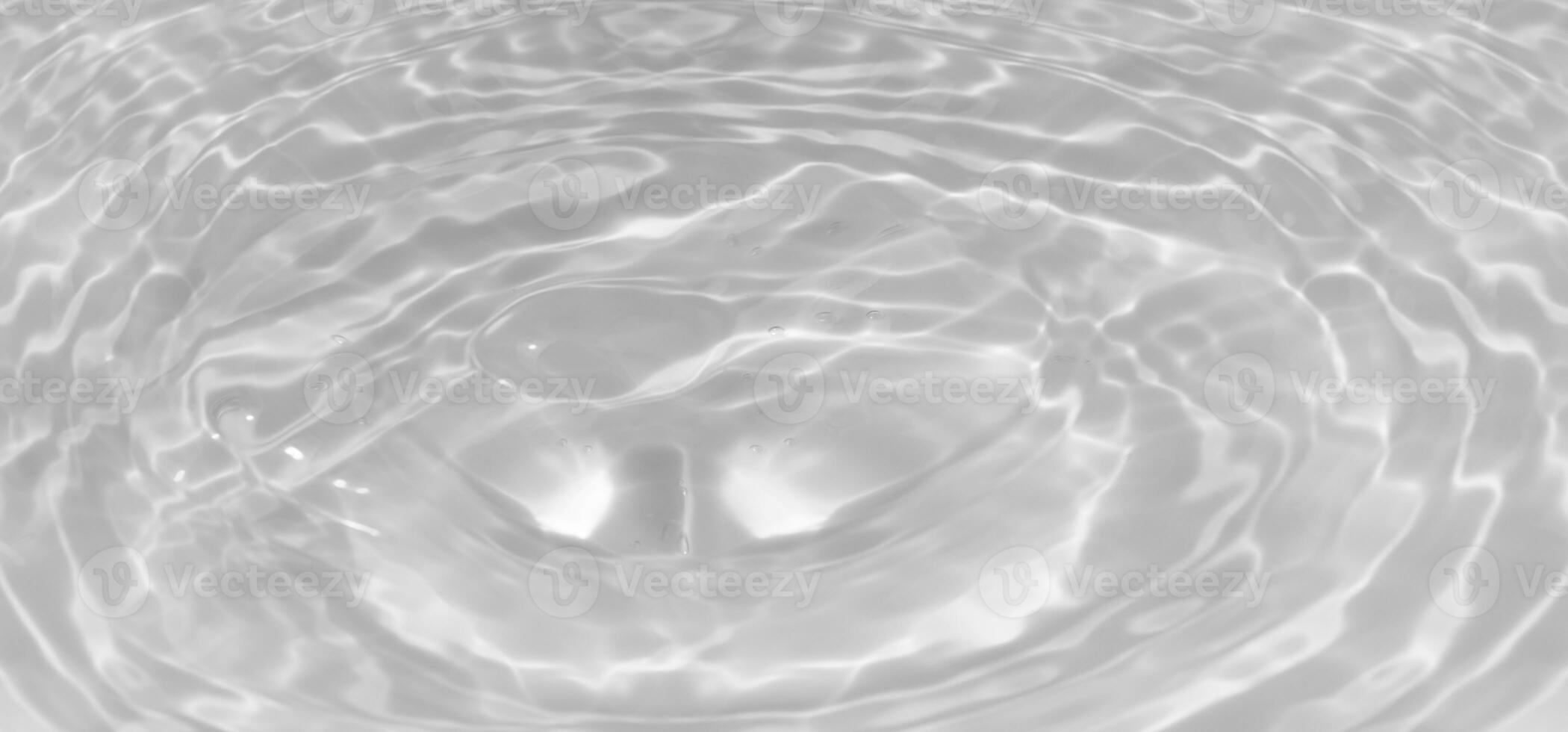 White water with ripples on the surface. Defocus blurred transparent white colored clear calm water surface texture with splashes and bubbles. Water waves with shining pattern texture background. photo