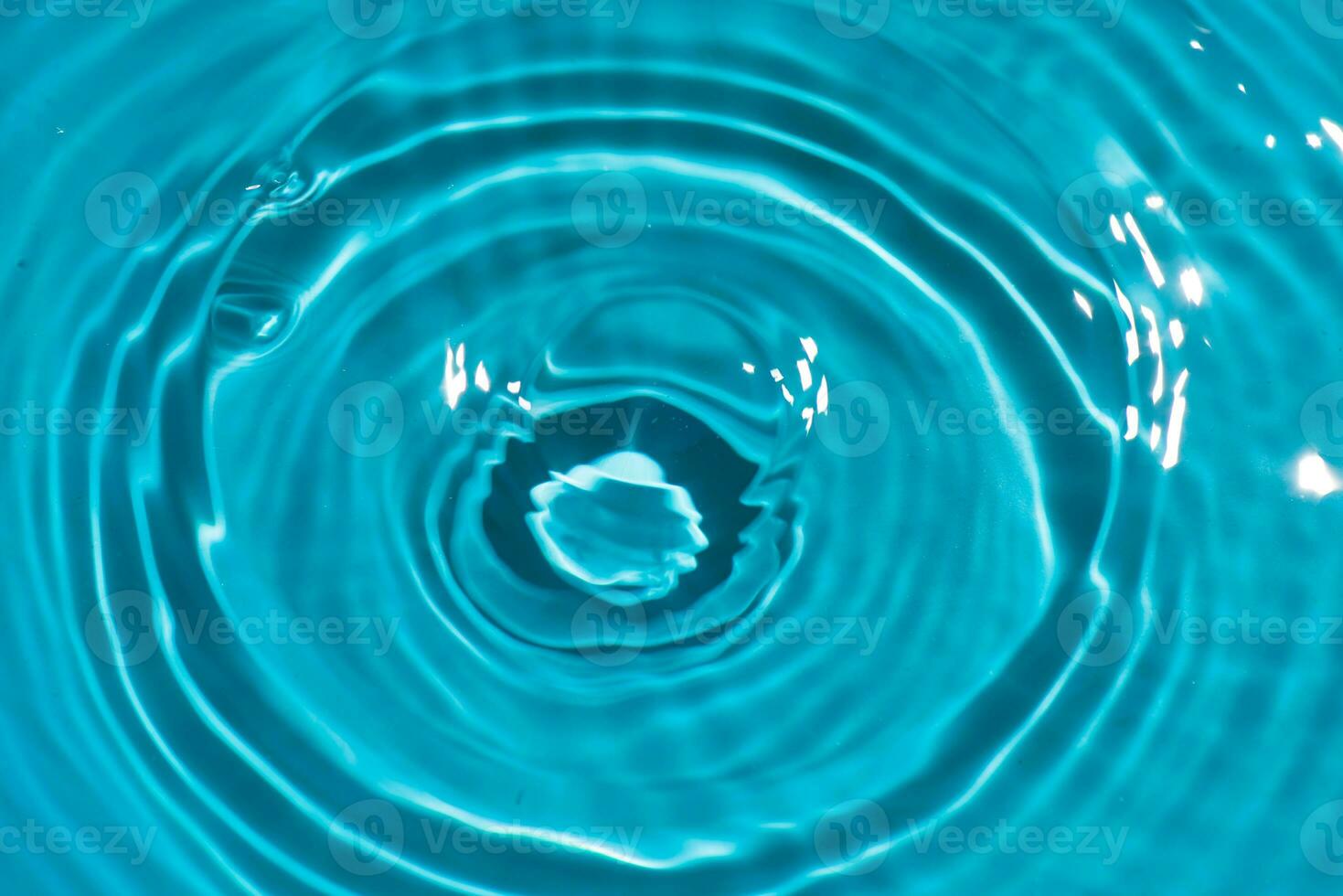 Defocus blurred transparent blue colored clear calm water surface texture with splashes reflection. Trendy abstract nature background. Water waves in sunlight with copy space. Blue watercolor shine. photo