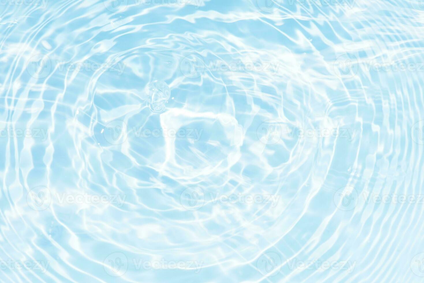 Defocus blurred transparent blue colored clear calm water surface texture with splashes reflection. Trendy abstract nature background. Water waves in sunlight with copy space. Blue watercolor shine. photo