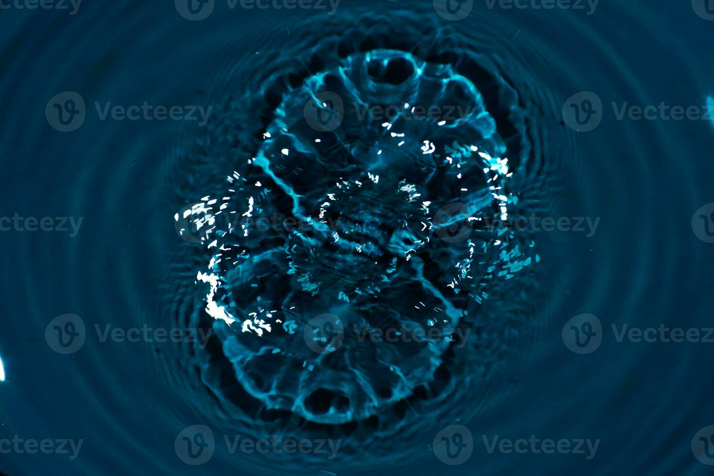 Defocus blurred transparent blue colored clear calm water surface texture with splashes reflection. Trendy abstract nature background. Water waves in sunlight with copy space. Blue watercolor shine. photo
