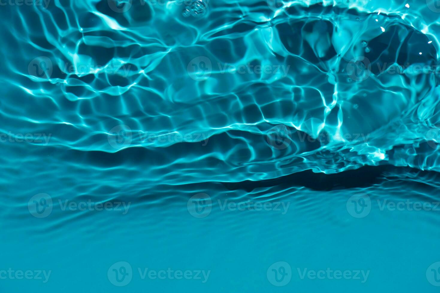 Defocus blurred transparent blue colored clear calm water surface texture with splashes reflection. Trendy abstract nature background. Water waves in sunlight with copy space. Blue watercolor shine. photo