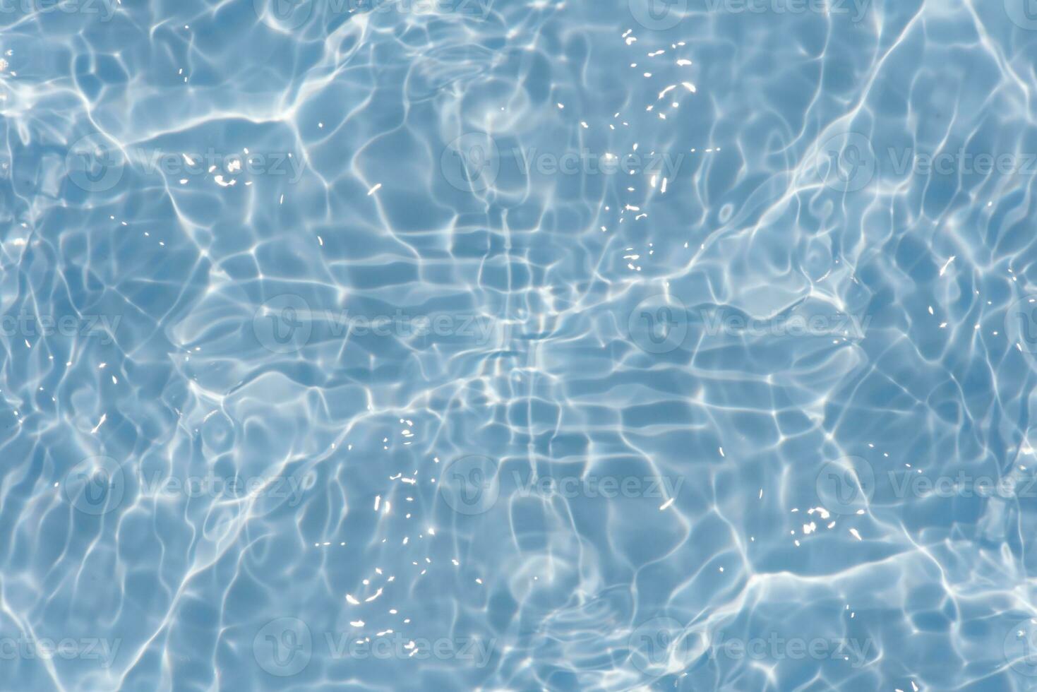 Defocus blurred transparent blue colored clear calm water surface texture with splashes reflection. Trendy abstract nature background. Water waves in sunlight with copy space. Blue watercolor shine. photo