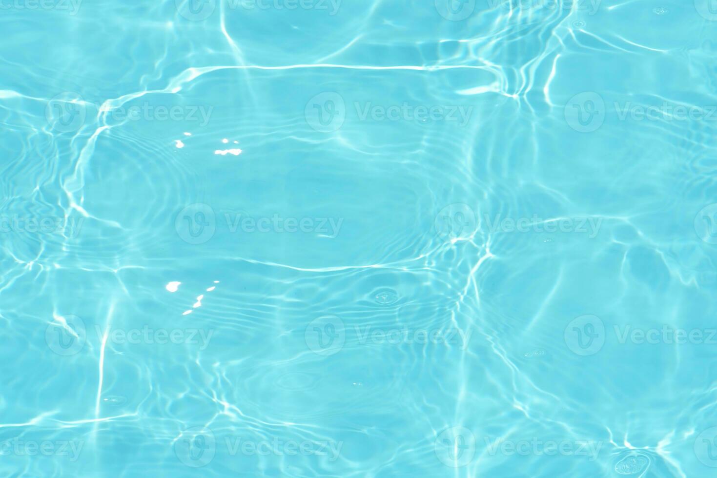 Defocus blurred transparent blue colored clear calm water surface texture with splashes reflection. Trendy abstract nature background. Water waves in sunlight with copy space. Blue watercolor shine. photo