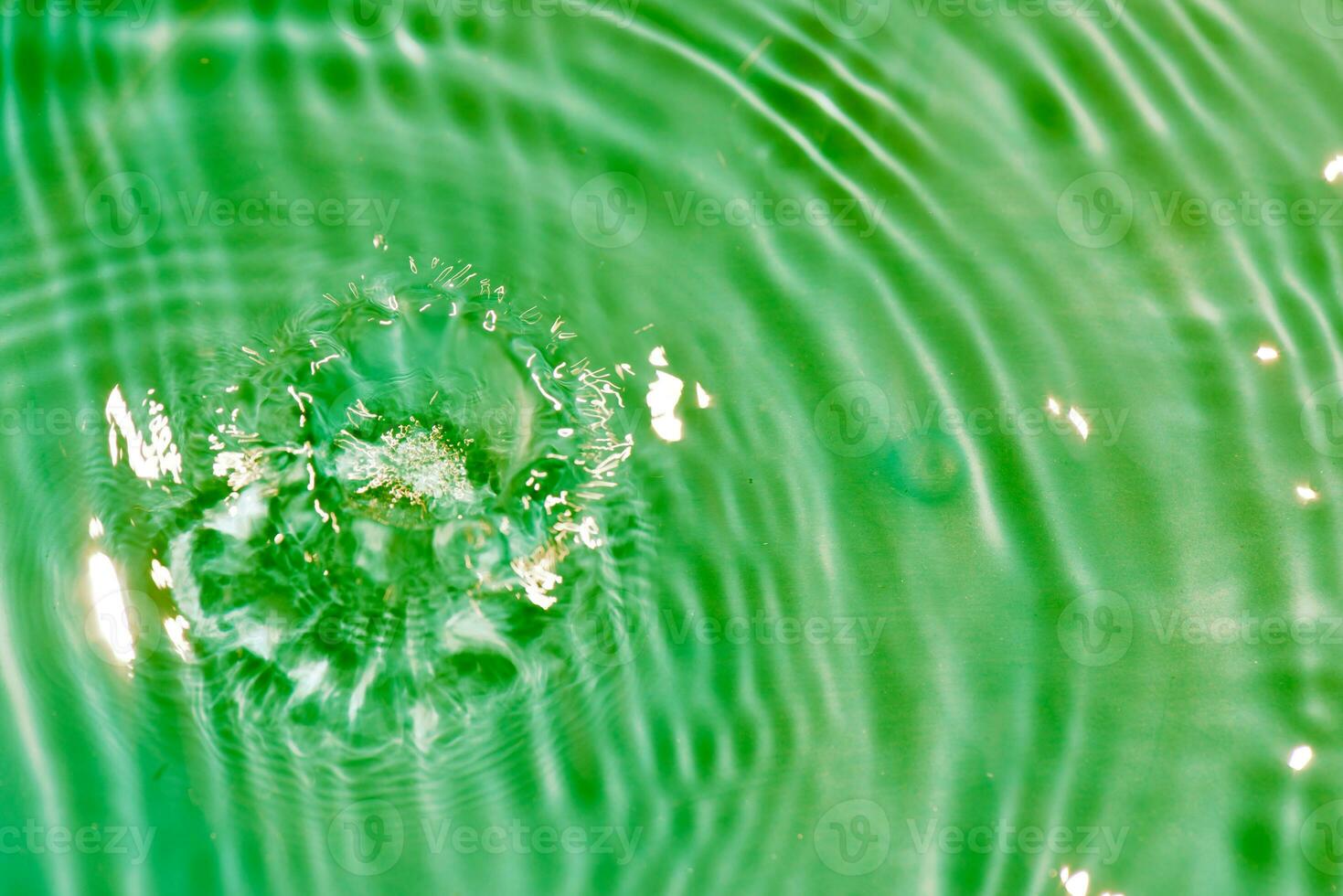 Defocus blurred transparent blue colored clear calm water surface texture with splashes reflection. Trendy abstract nature background. Water waves in sunlight with copy space. Blue watercolor shine. photo