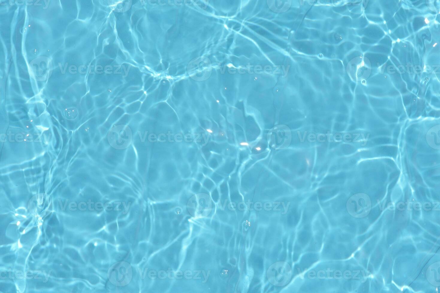Defocus blurred transparent blue colored clear calm water surface texture with splashes reflection. Trendy abstract nature background. Water waves in sunlight with copy space. Blue watercolor shine. photo