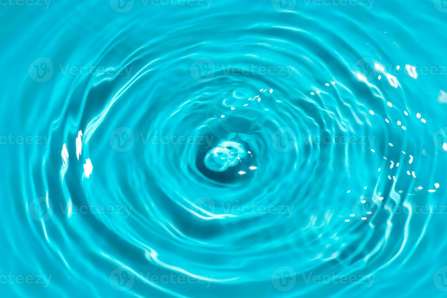 Defocus blurred transparent blue colored clear calm water surface texture with splashes reflection. Trendy abstract nature background. Water waves in sunlight with copy space. Blue watercolor shine. photo