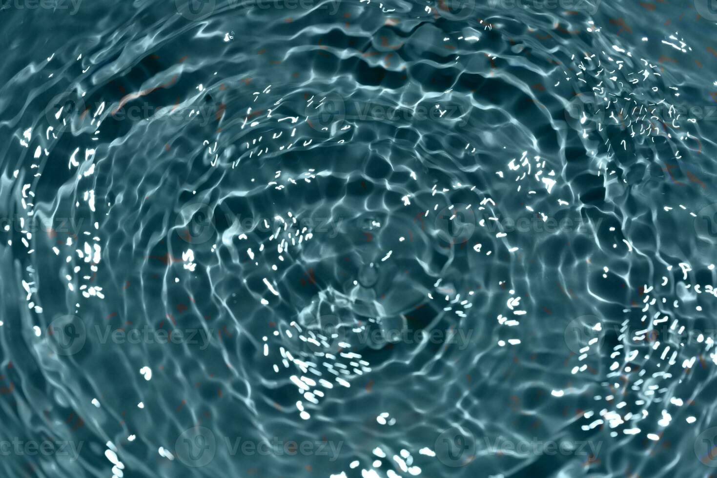 Defocus blurred transparent blue colored clear calm water surface texture with splashes reflection. Trendy abstract nature background. Water waves in sunlight with copy space. Blue watercolor shine. photo