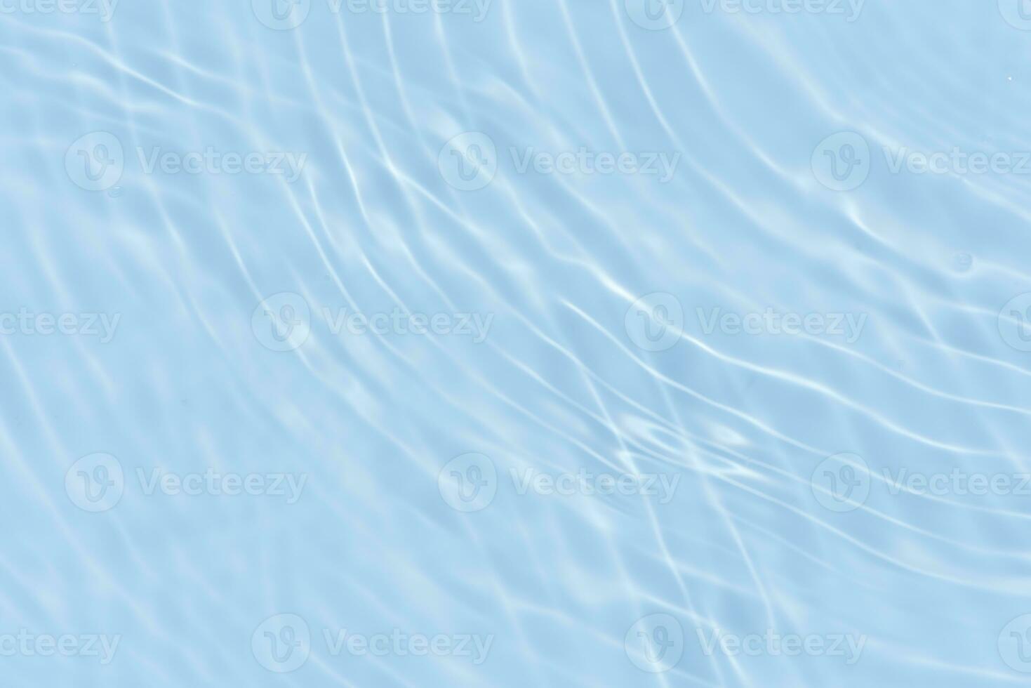 Defocus blurred transparent blue colored clear calm water surface texture with splashes reflection. Trendy abstract nature background. Water waves in sunlight with copy space. Blue watercolor shine. photo