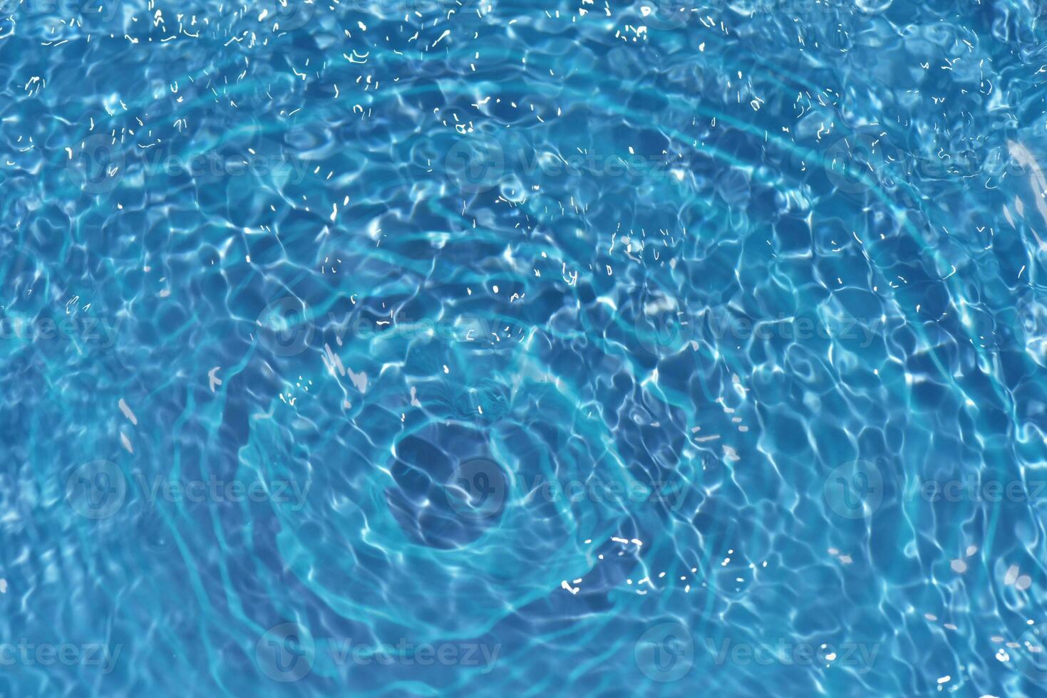 Defocus blurred transparent blue colored clear calm water surface texture with splashes reflection. Trendy abstract nature background. Water waves in sunlight with copy space. Blue watercolor shine. photo