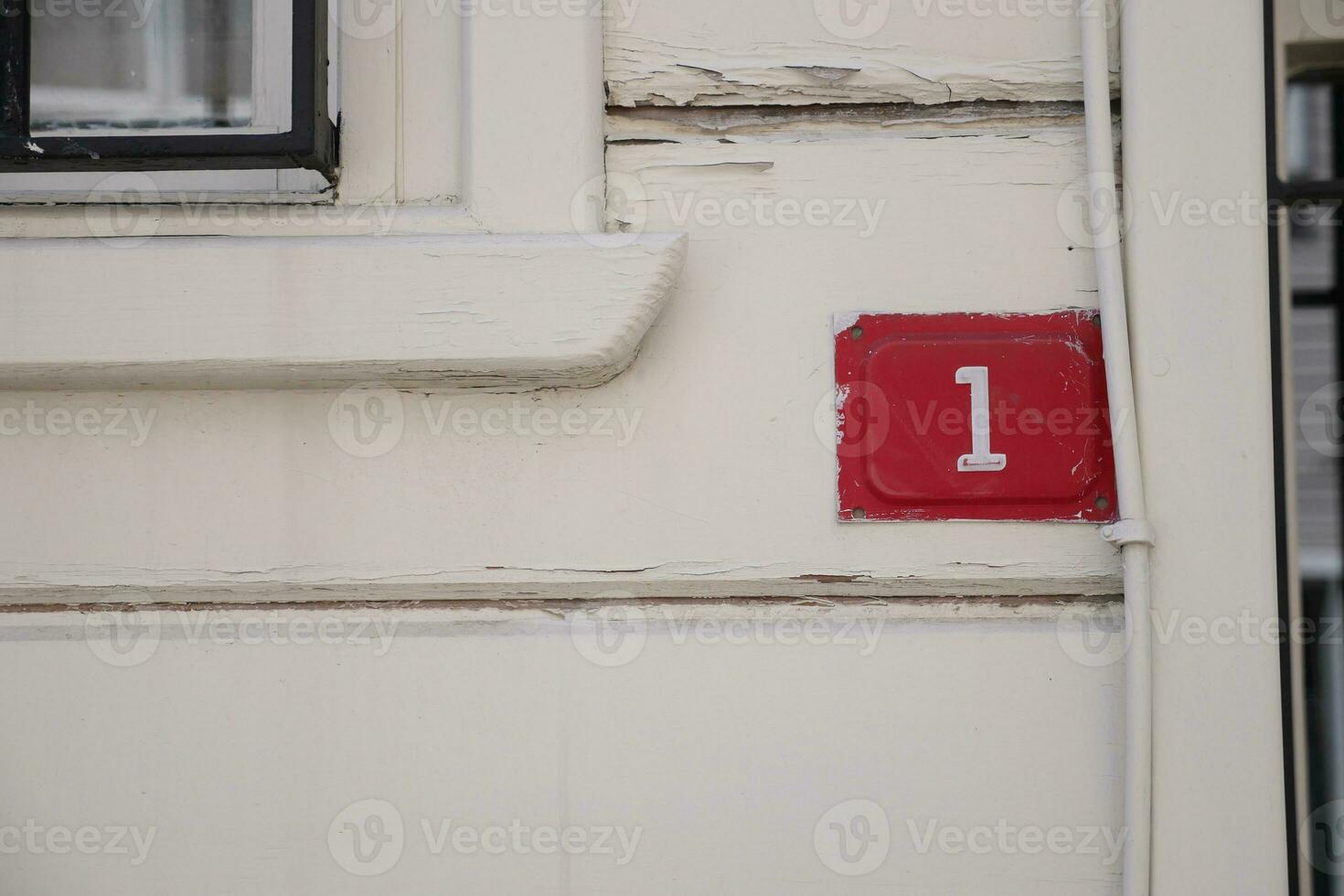 house number 1 plate a brick wall. photo