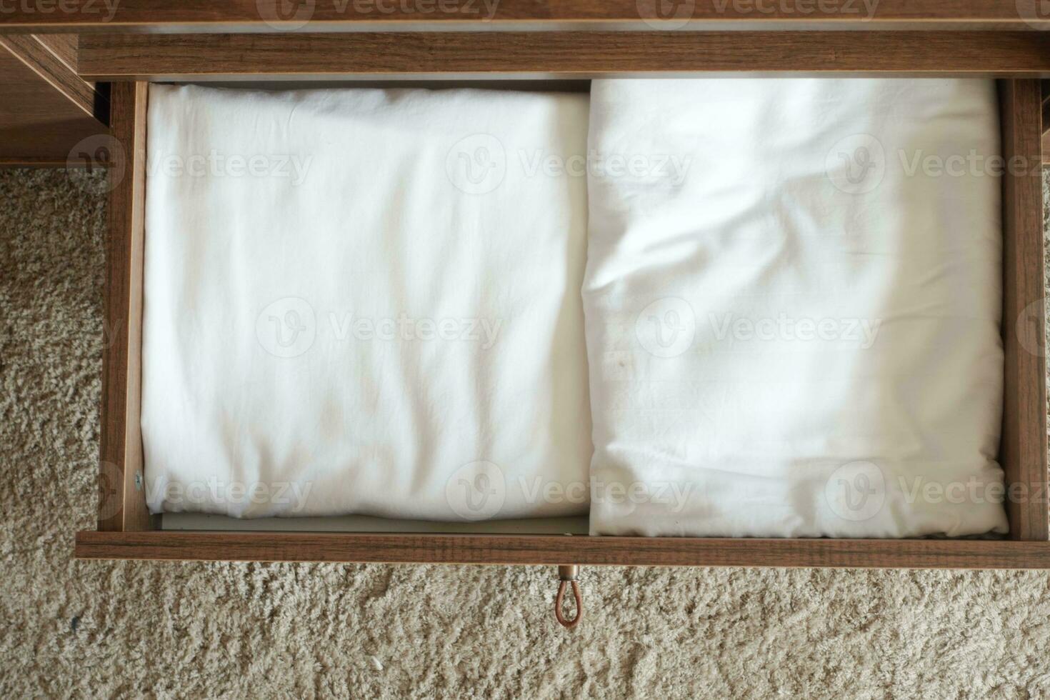 top view of white cloths in a open drawer wooden photo