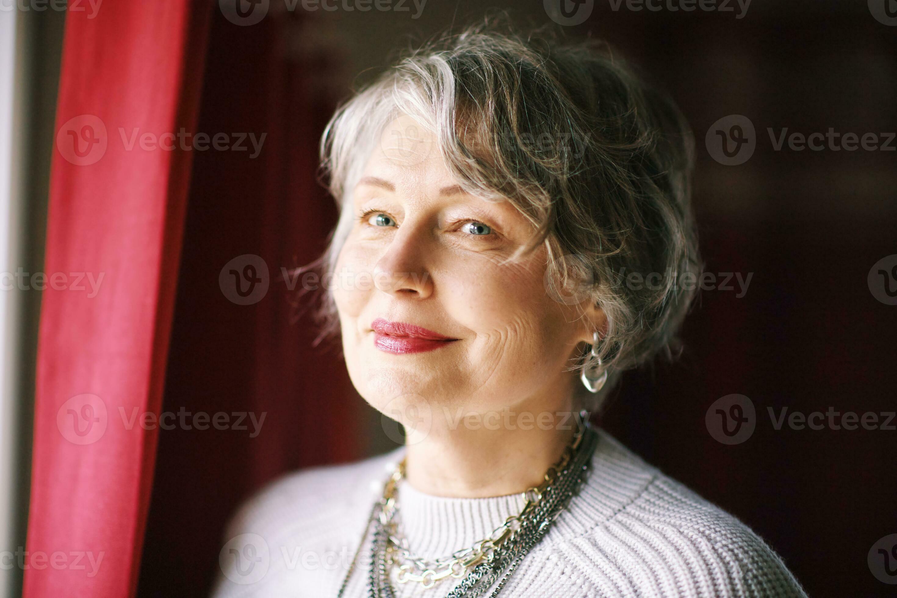 Close up portrait of beautiful 50 55 year old woman with grey hair