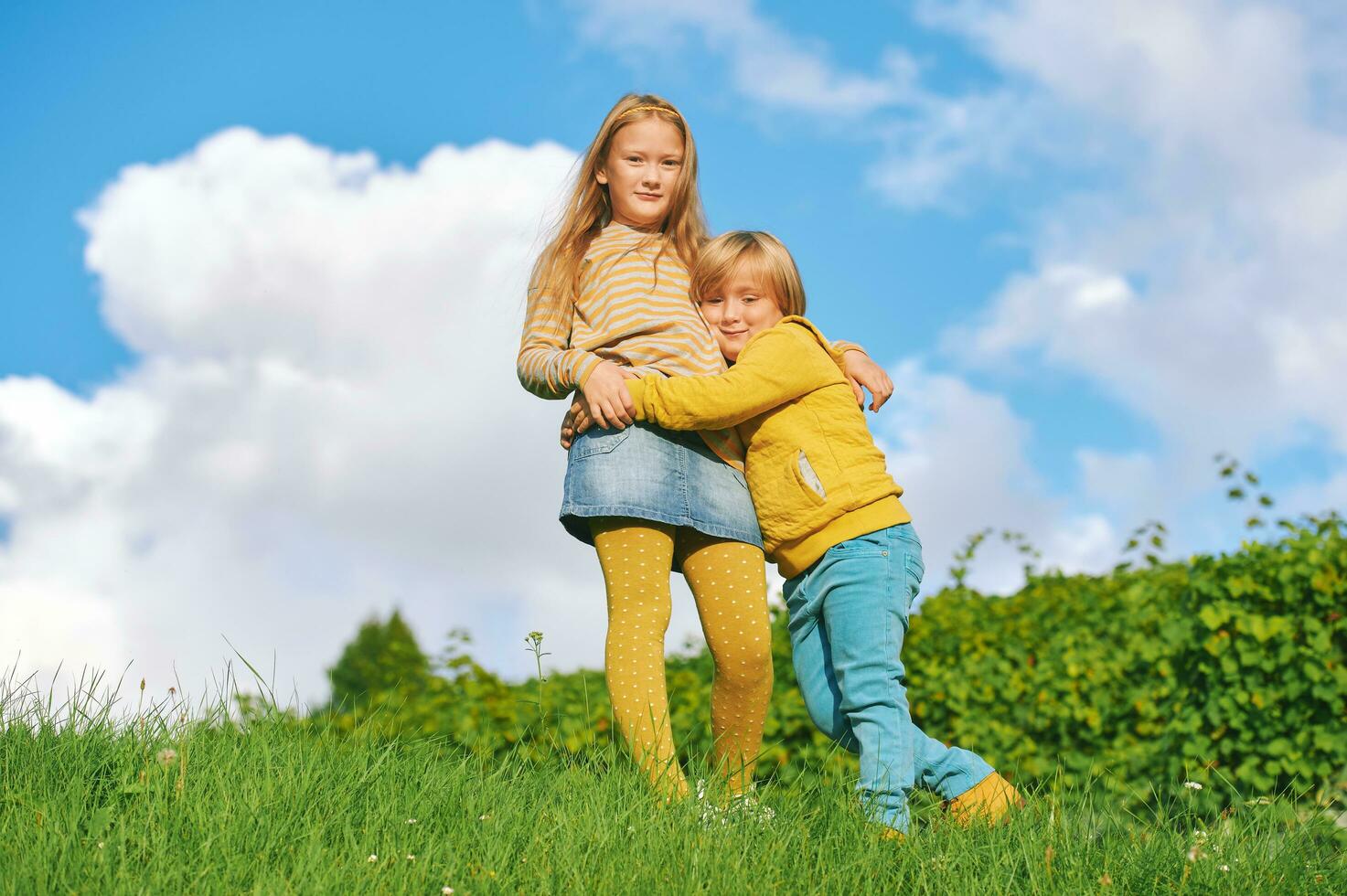 Portrait of 2 funny children playing together outside photo