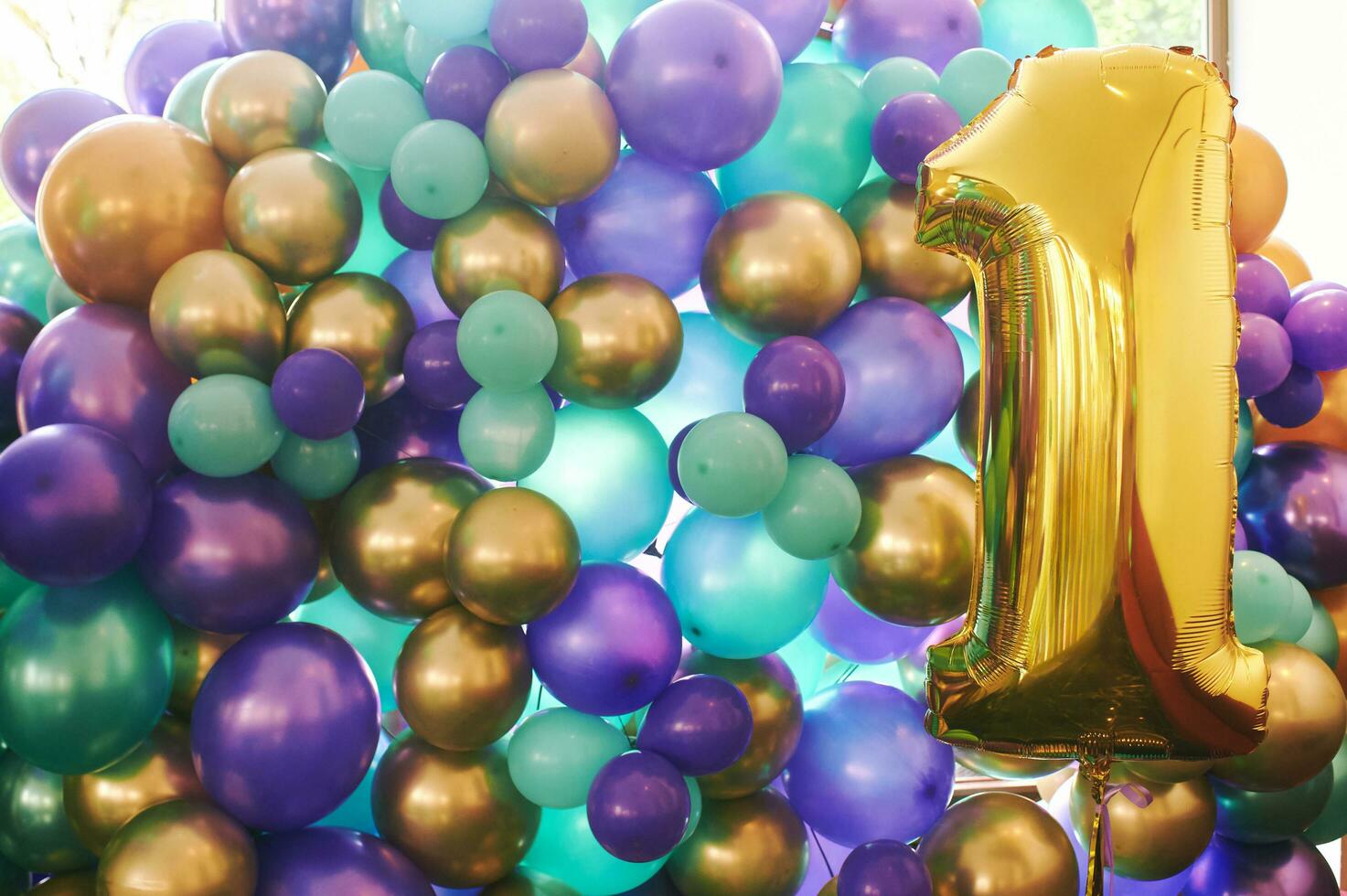 Background with many colorful balloons and number one shaped golden balloon, party concept photo