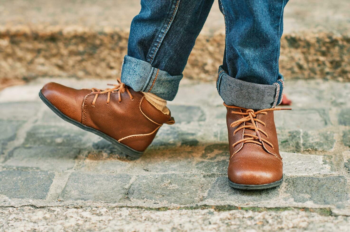 Close up image of brown leather vintage shoes wearing by a child photo