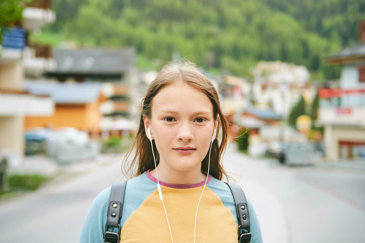 Young teen girl hiking in mountain, visiting traditional swiss village, Leukerbad, Switzerland photo