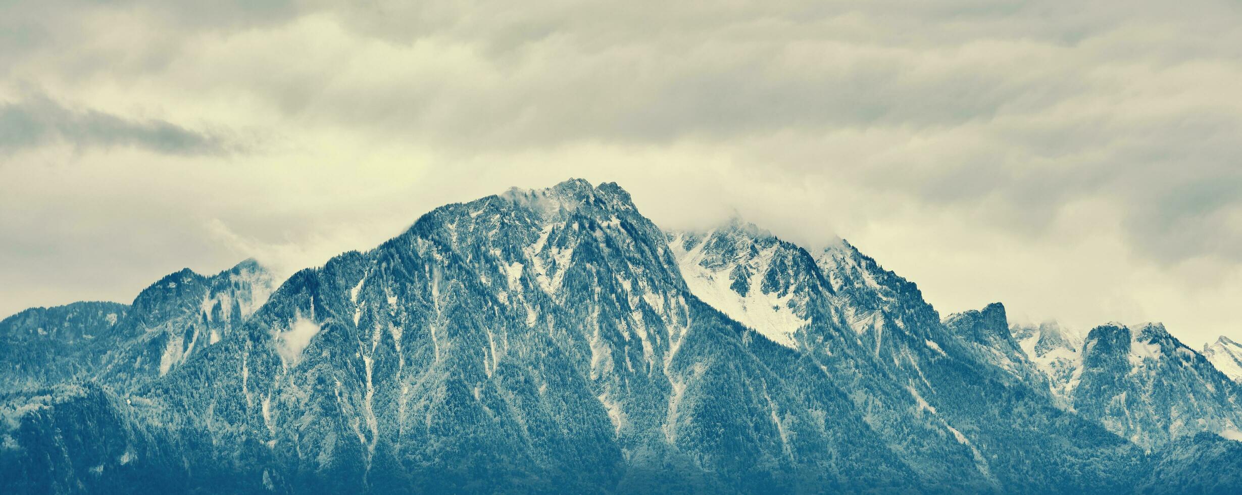 Panoramic banner landscape alpine mountain under first snow photo