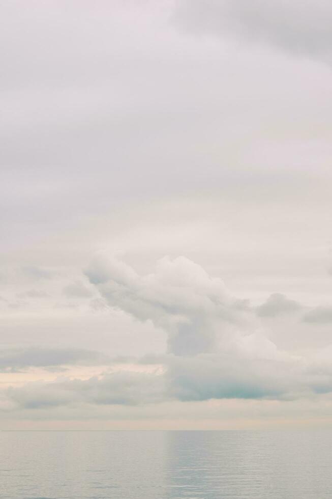 Nature background with big fluffy cloud over the lake, light pastel palette photo