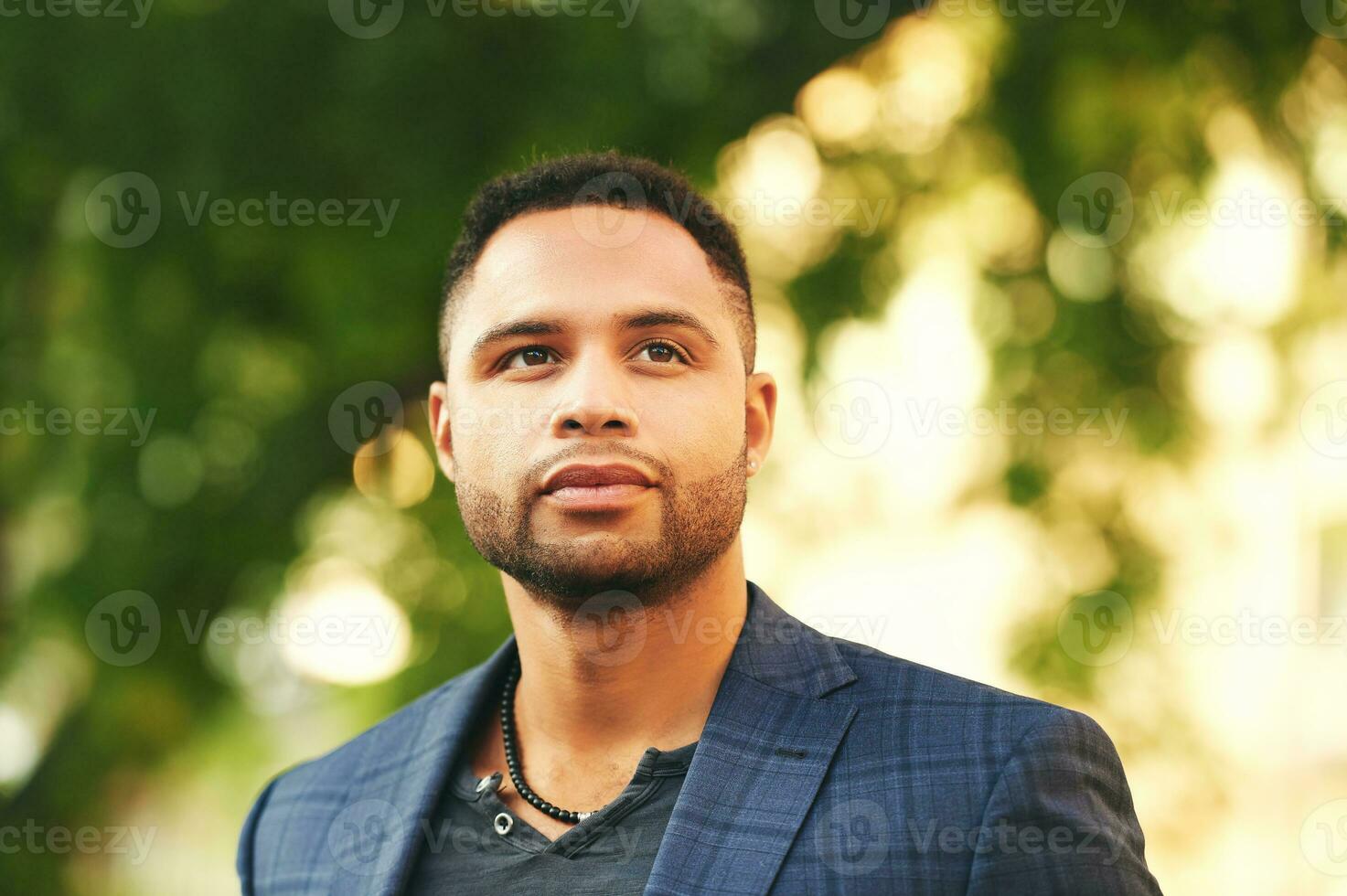 Outdoor close up portrait of handsome african american man at sunset photo