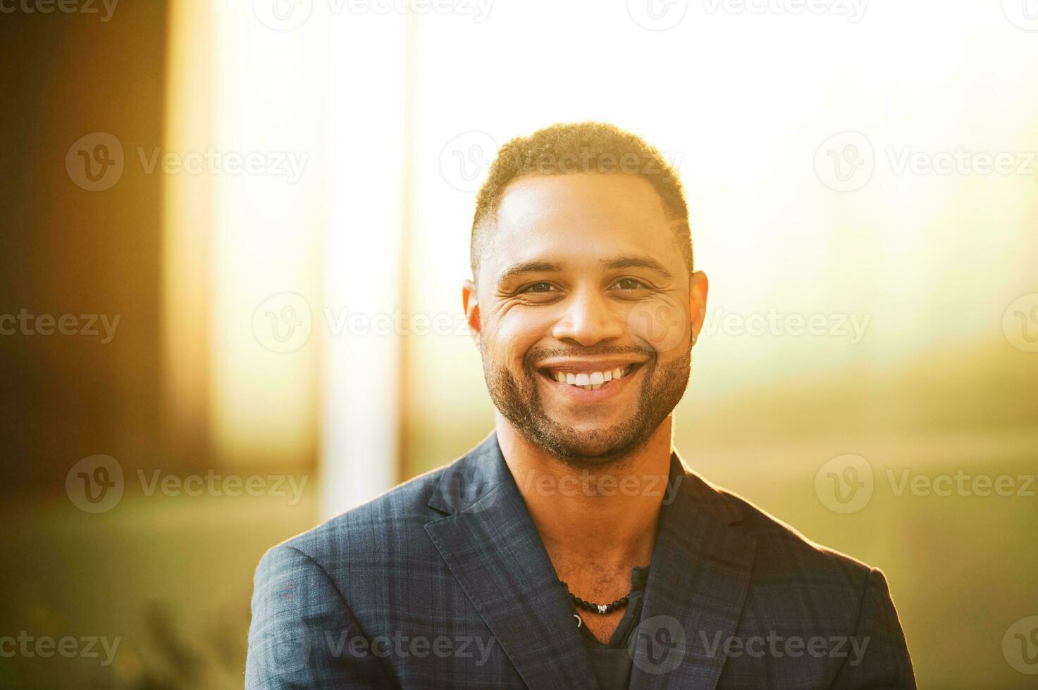 Outdoor close up portrait of handsome african american man at sunset photo