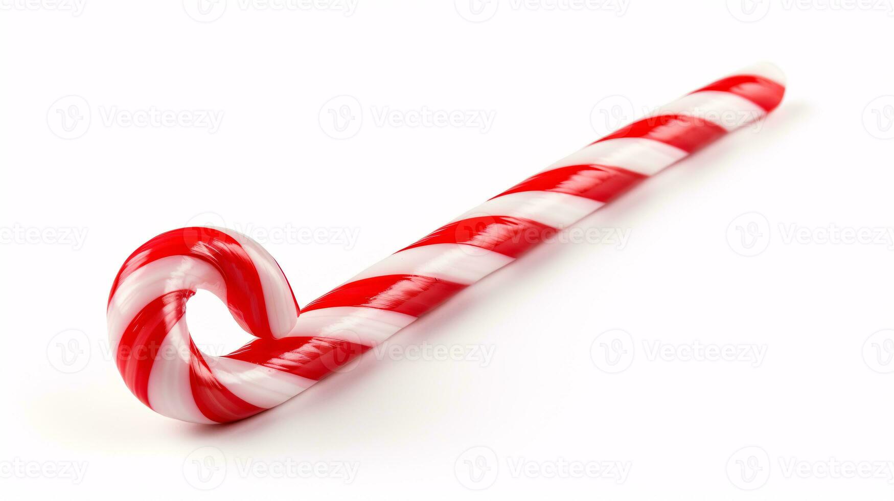 A candy cane is tightly framed against a blank surface. photo