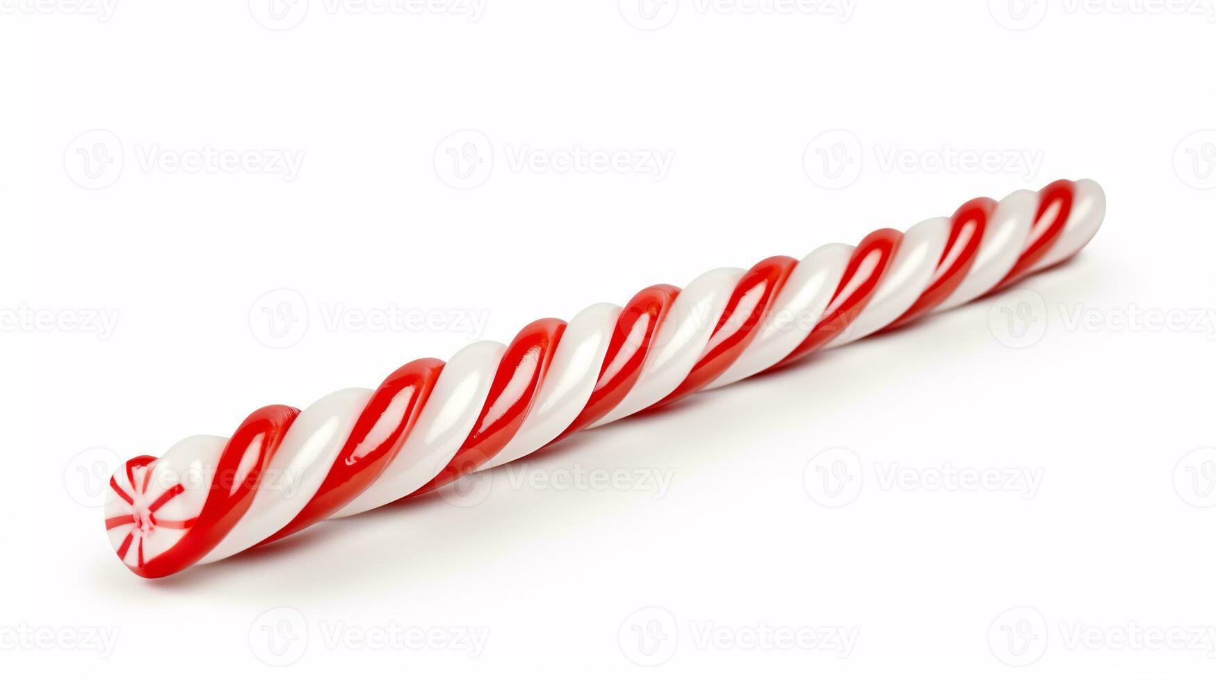 A candy cane is sharply depicted against a white backdrop. photo