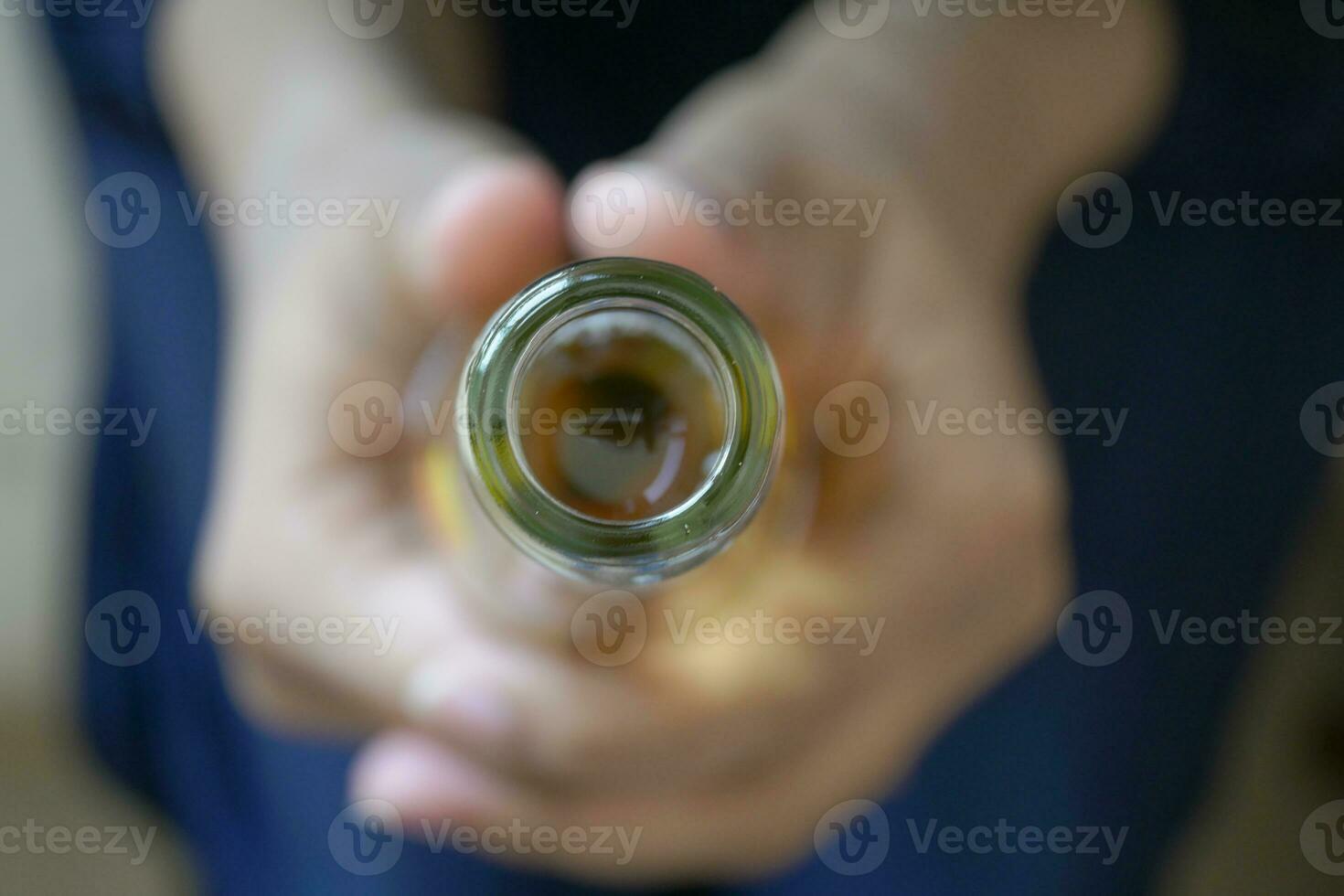 Metal cap and opener on the glass bottle photo