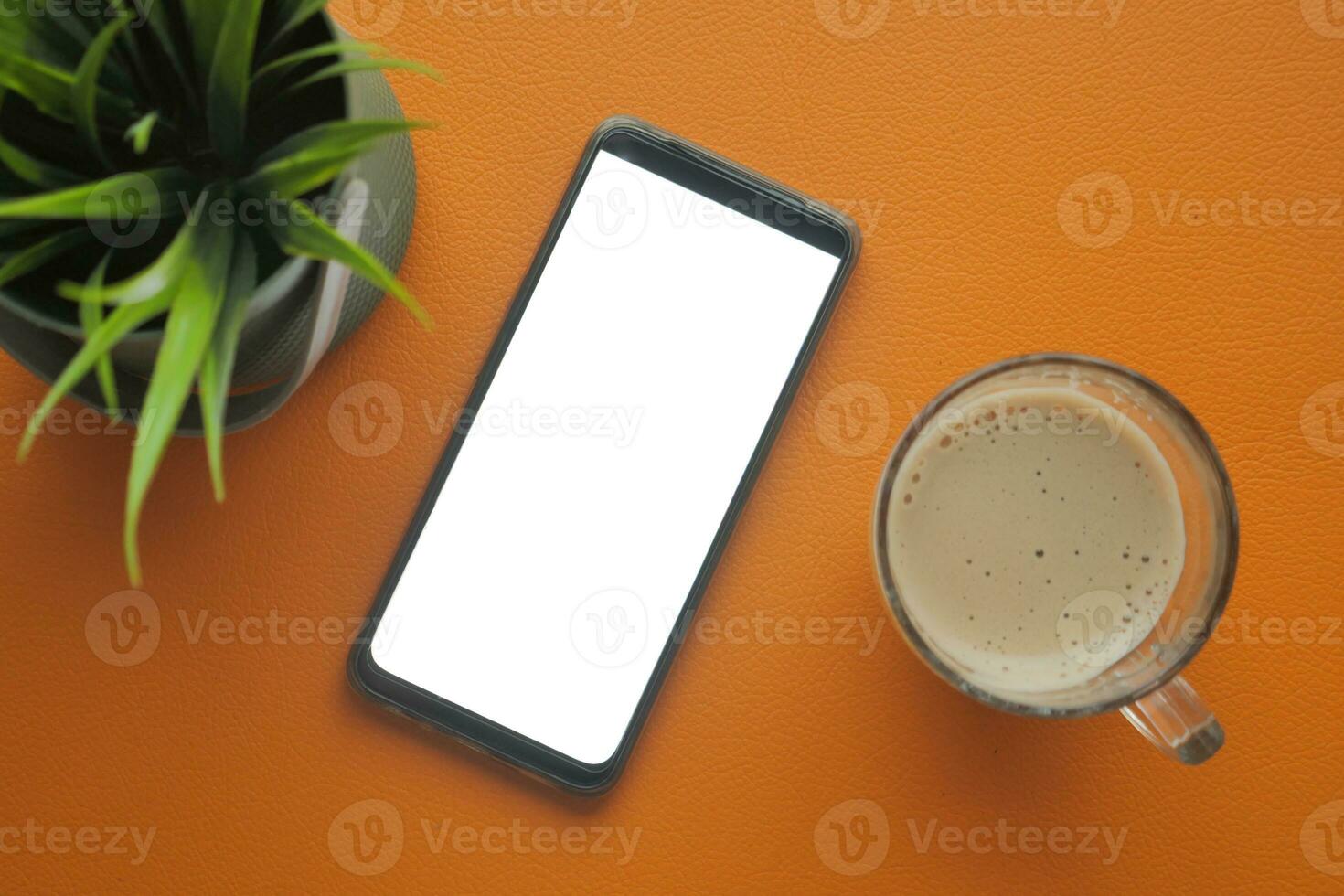 smart phone with empty white screen and cup of coffee on table photo