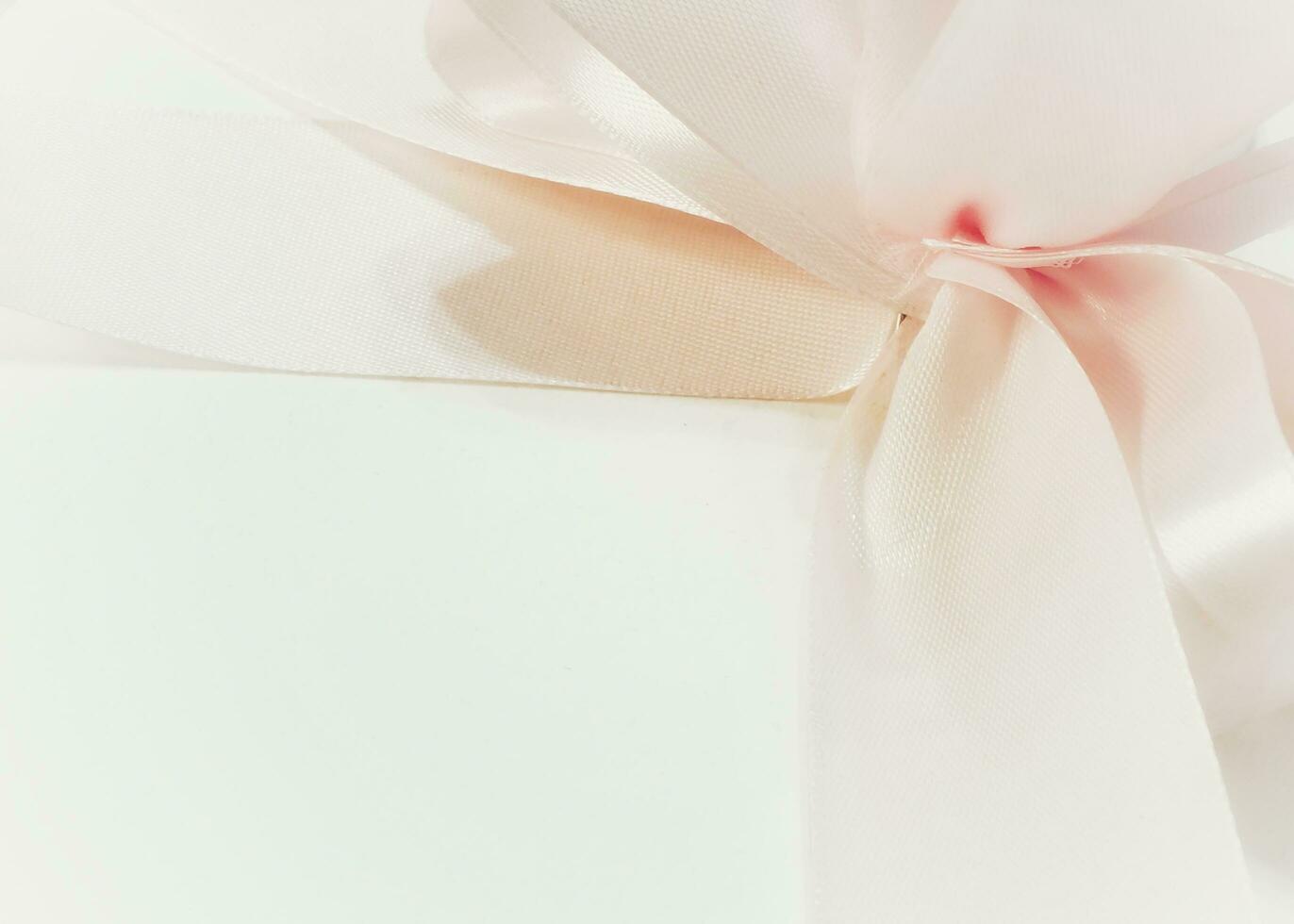 A pink ribbon isolated on a white background. Pink curly ribbon. Empty space for design. Romantic background image photo