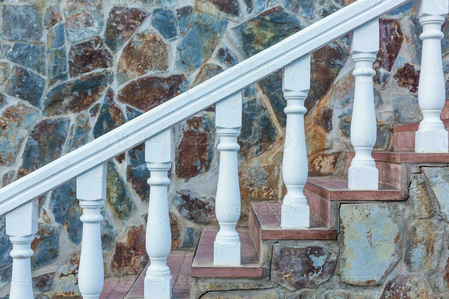 Stone baroque baluster and staircase, stone wall. photo