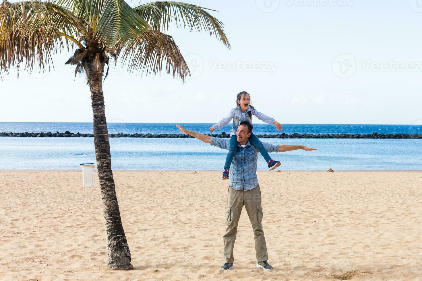 Father and Daughter playing at the beach photo