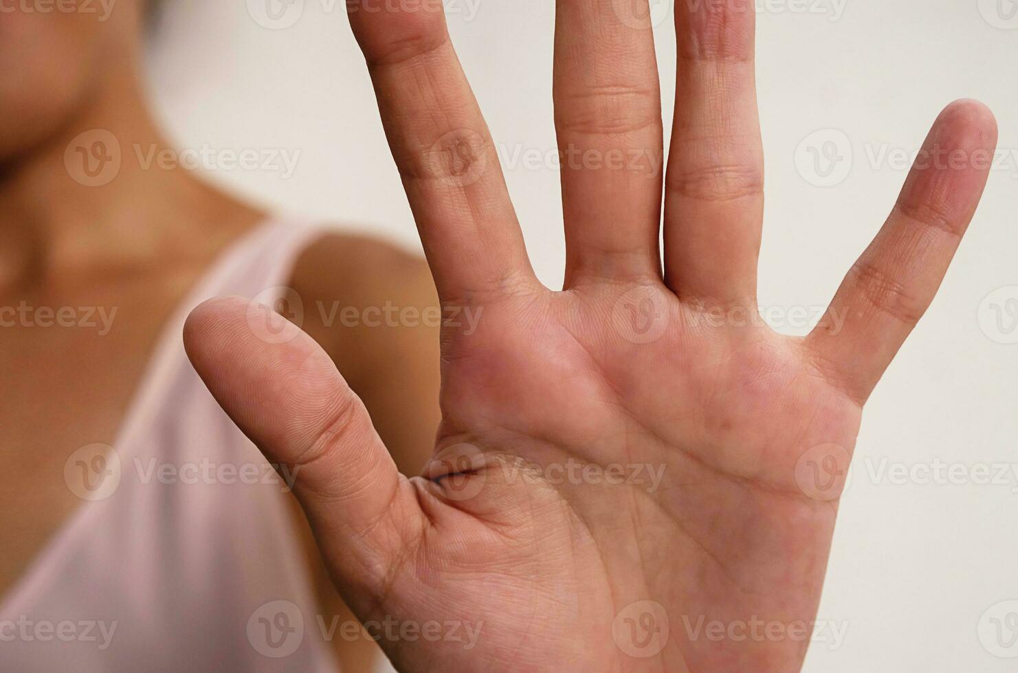 Female making stop gesture, close up. photo