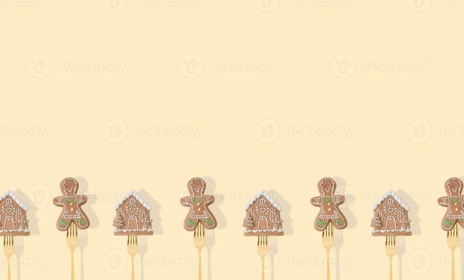Gingerbread Christmas tree decorations pricked on a forks on pastel beige background. Minimal style New Year party background. Creative Christmas or New Year concept. Winter holidays idea. Copy space. photo