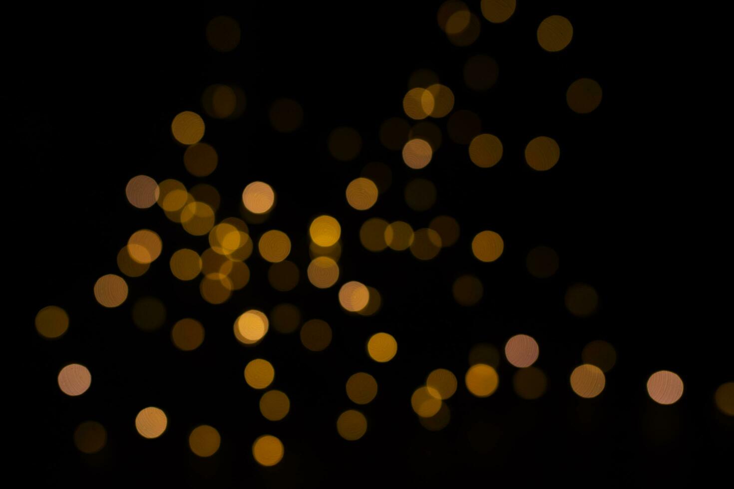 Abstract golden yellow circular blurred bokeh lights for a festive background. Defocused photo