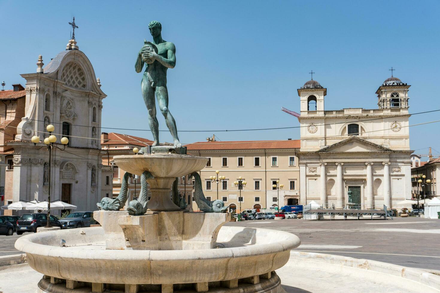 L'Aquila, Italy-august 11, 2021-view of the old fountain in the cathedral square in L'Aquila during a sunny day photo