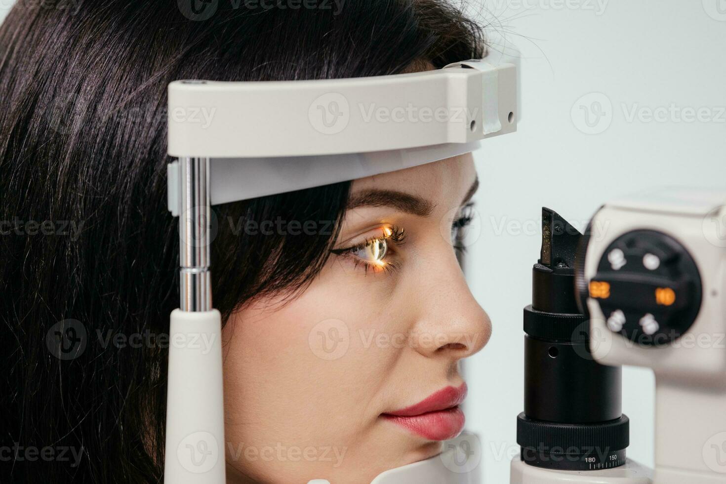 Eye iris and pupil macro. Reflected moving light rays into the human eye with zoom. Close up. The concept of ophthalmology and medicine. Medical attendance at the optometrist in a bright modern clinic photo