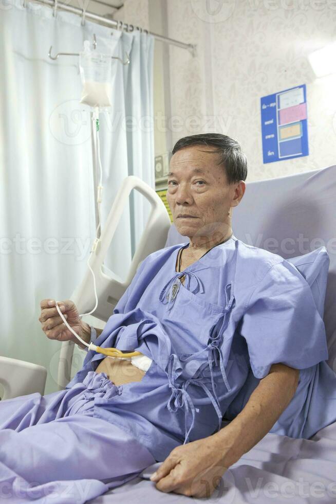 asian patient lying on hospital bed photo