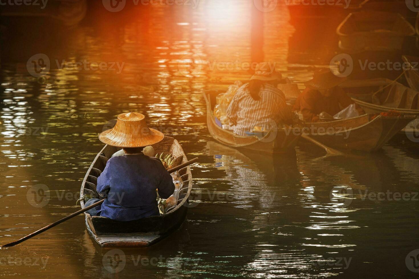 woman sailing thai trading boat in floating maket most popular traveling destination in dumnern sadauk canal ratchaburi thailand photo