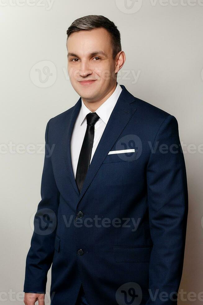 Portrait of handsome man in black blue suit photo