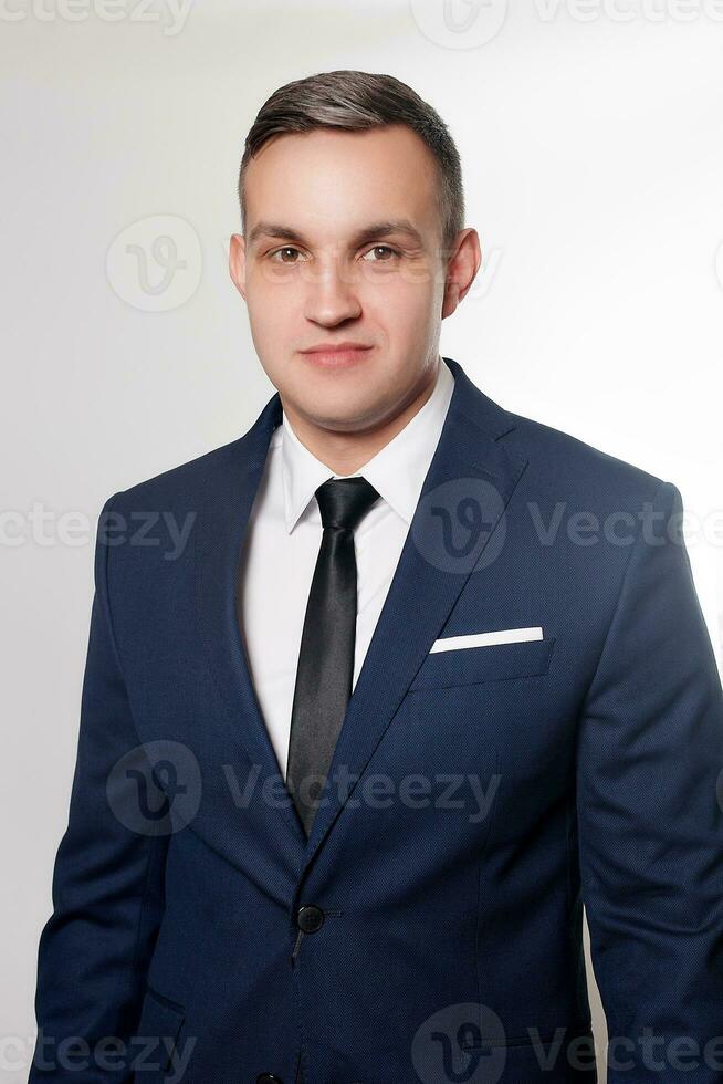 Portrait of handsome man in black blue suit photo