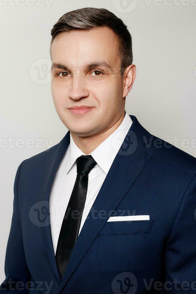 Portrait of handsome man in black blue suit photo