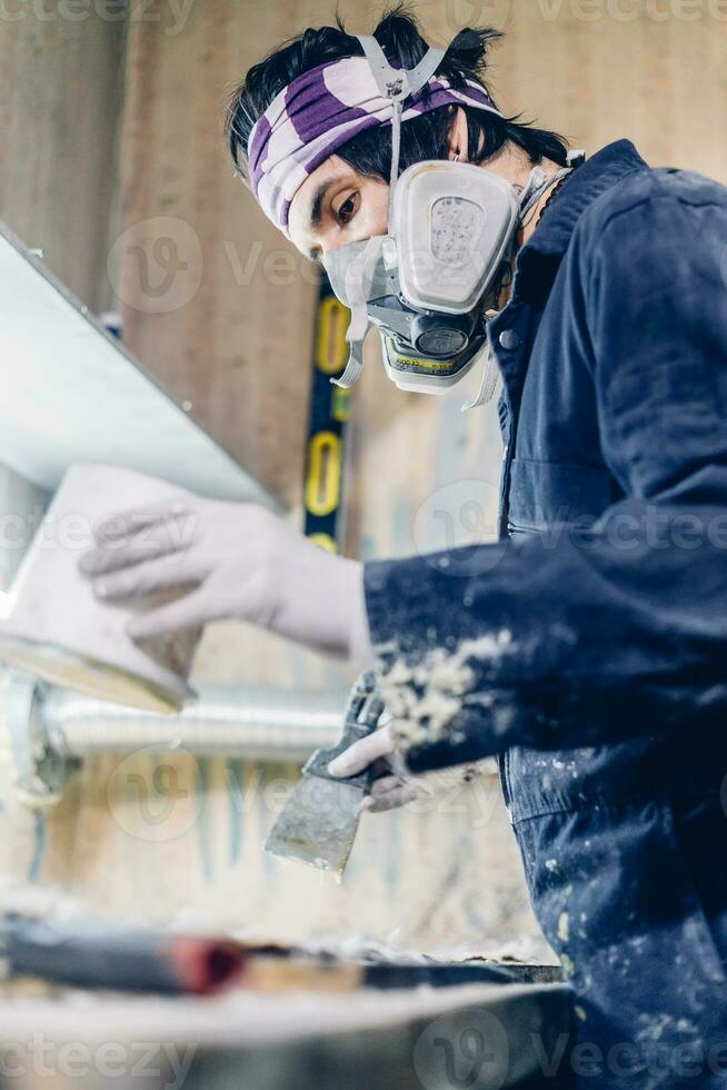 guy makes glue and glues wooden panels on the manufacture of skateboards photo