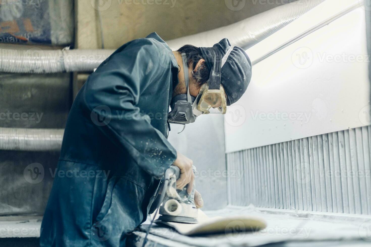 A carpenter cuts a board with an electric jigsaw. photo