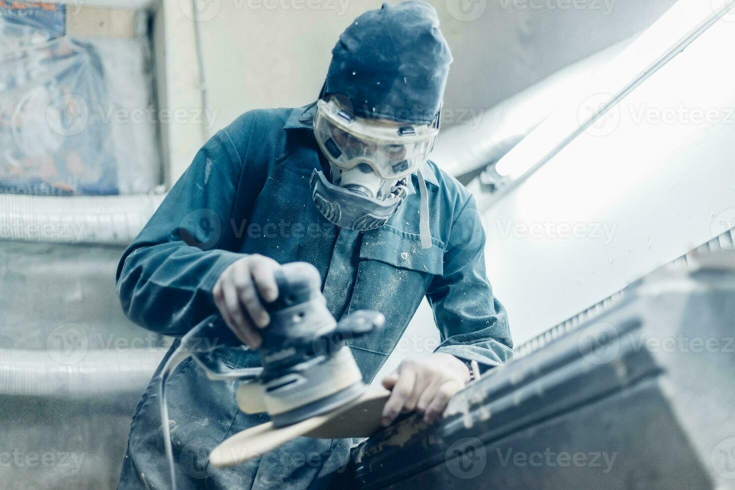 A carpenter cuts a board with an electric jigsaw. photo